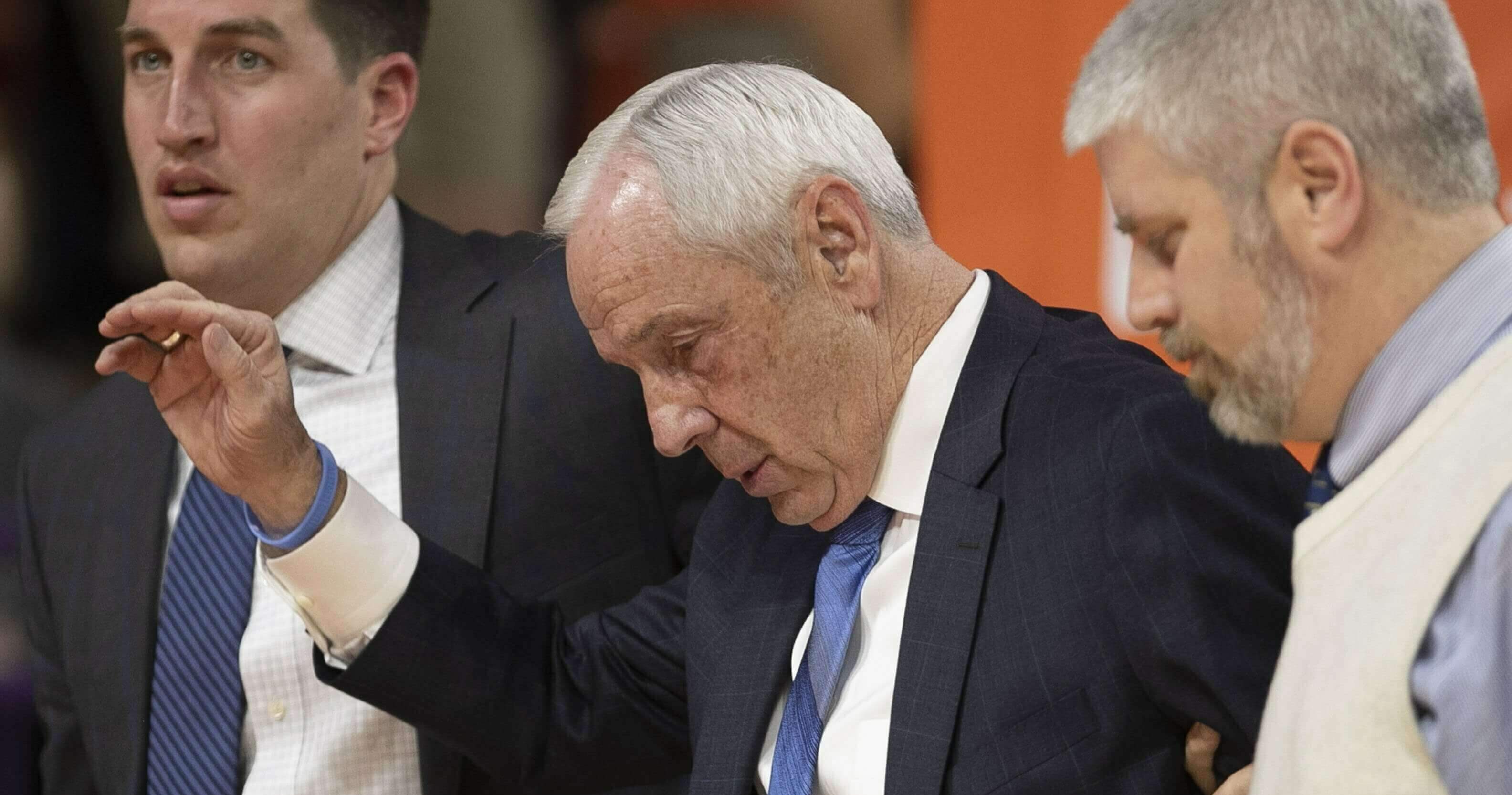 North Carolina coach Roy Williams is escorted off the court and waves, after falling near the bench during the first half of the team's NCAA college basketball game against Clemson on Saturday, Mar. 2, 2019, in Clemson, S.C.