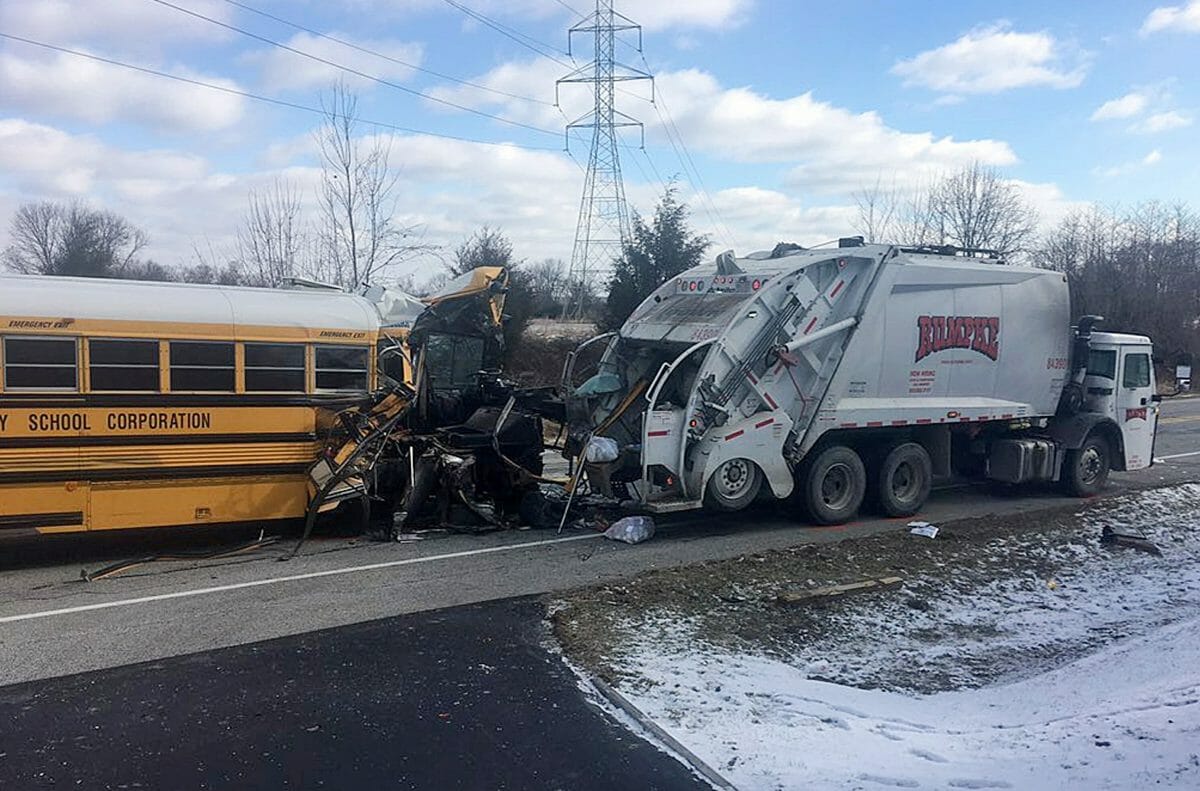This image provided by the Indiana State Police shows a school bus that collided with a garbage truck, Wednesday, March 6, 2019, near Aurora, Indiana.