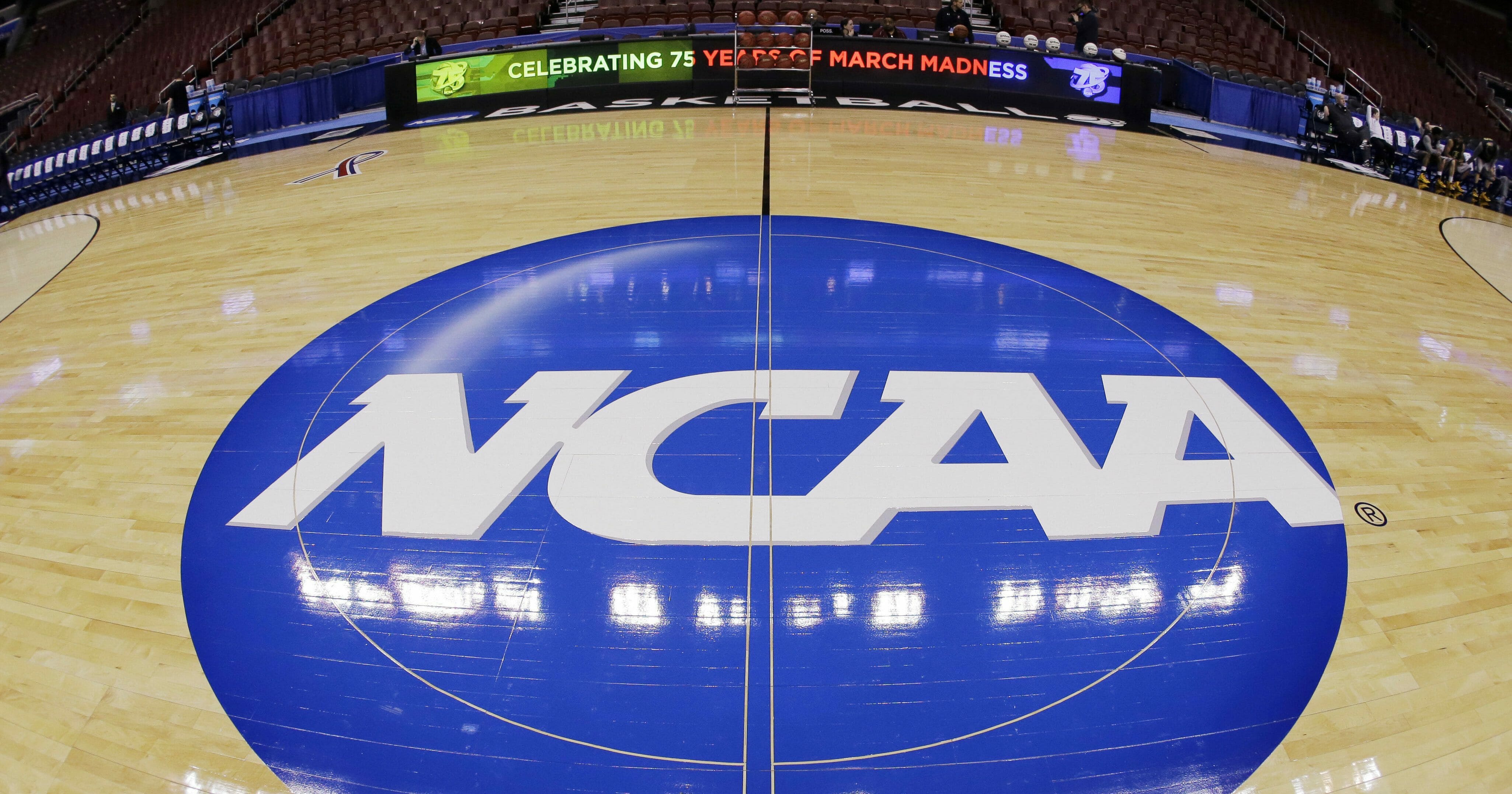 In a March 21, 2013, photo taken with a fisheye lens, the NCAA logo is displayed at midcourt before Albany's practice for a second-round NCAA tournament game in Philadelphia.