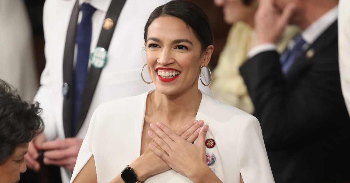 Rep. Alexandria Ocasio-Cortez (D-NY) greets fellow lawmakers ahead of the State of the Union address in the chamber of the U.S. House of Representatives.