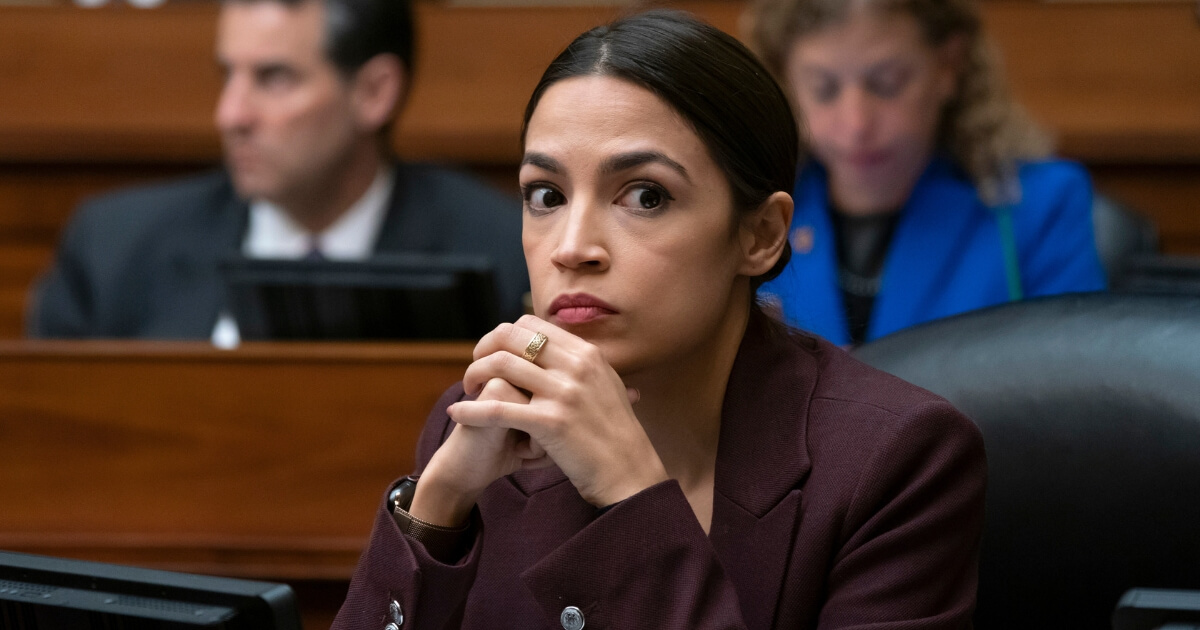 Rep. Alexandria Ocasio-Cortez, D-N.Y., listens to questioning of Michael Cohen, President Donald Trump's former personal lawyer, at the House Oversight and Reform Committee on Capitol Hill.