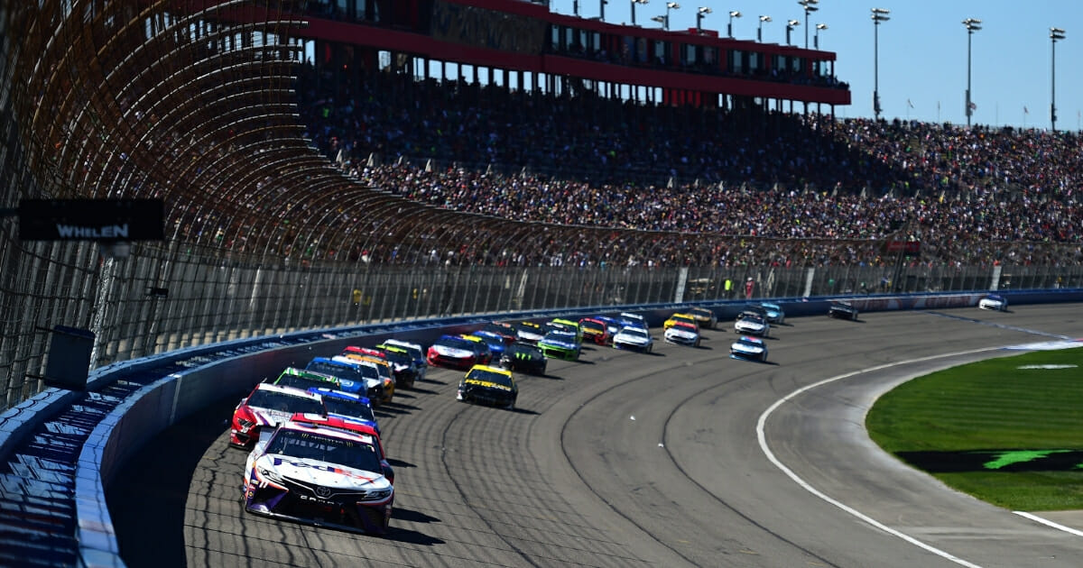Denny Hamlin, driver of the #11 FedEx Express Toyota, leads a pack of cars during the Monster Energy NASCAR Cup Series Auto Club 400.