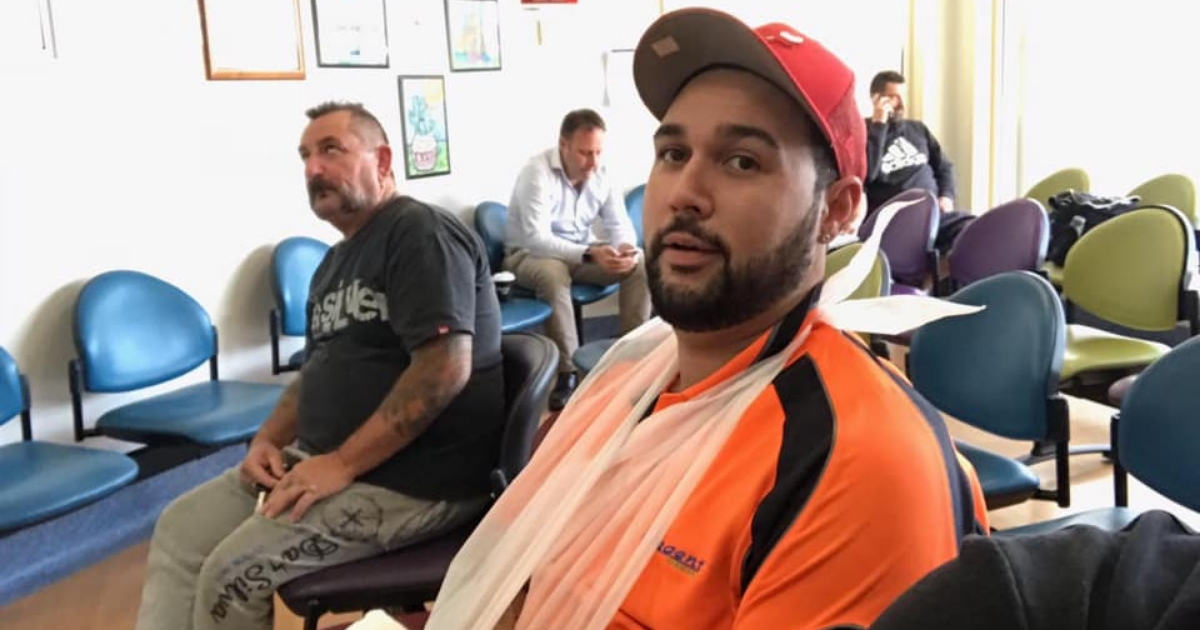 Man with sling in hospital.