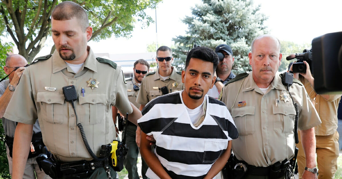 Cristhian Bahena Rivera is escorted into the Poweshiek County Courthouse for his initial court appearance.