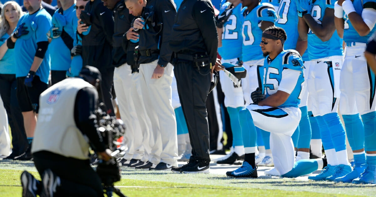 Eric Reid of the Carolina Panthers kneels during the national anthem.