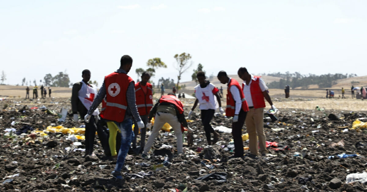 Red cross team work amid debris at the crash site of Ethiopia Airlines near Bishoftu, a town some 60 kilometres southeast of Addis Ababa, Ethiopia, on March 10, 2019. An Ethiopian Airlines Boeing 737 crashed on Sunday morning en route from Addis Ababa to Nairobi with 149 passengers and eight crew believed to be on board, Ethiopian Airlines said
