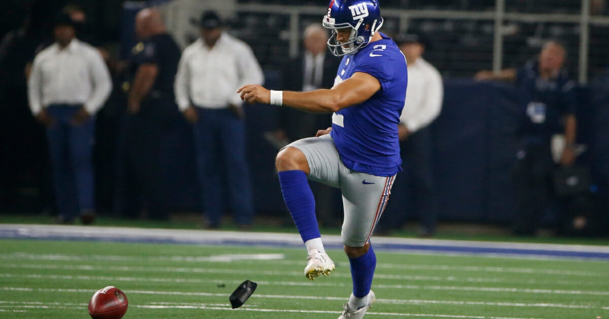 New York Giants kicker Aldrick Rosas attempts an onside kick against the Dallas Cowboys during a Sept. 16, 2018, game in Arlington, Texas.