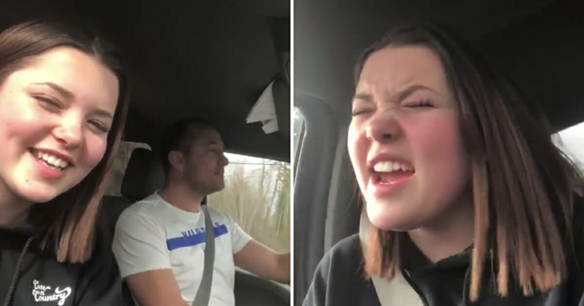 Girl singing in the car with her dad.