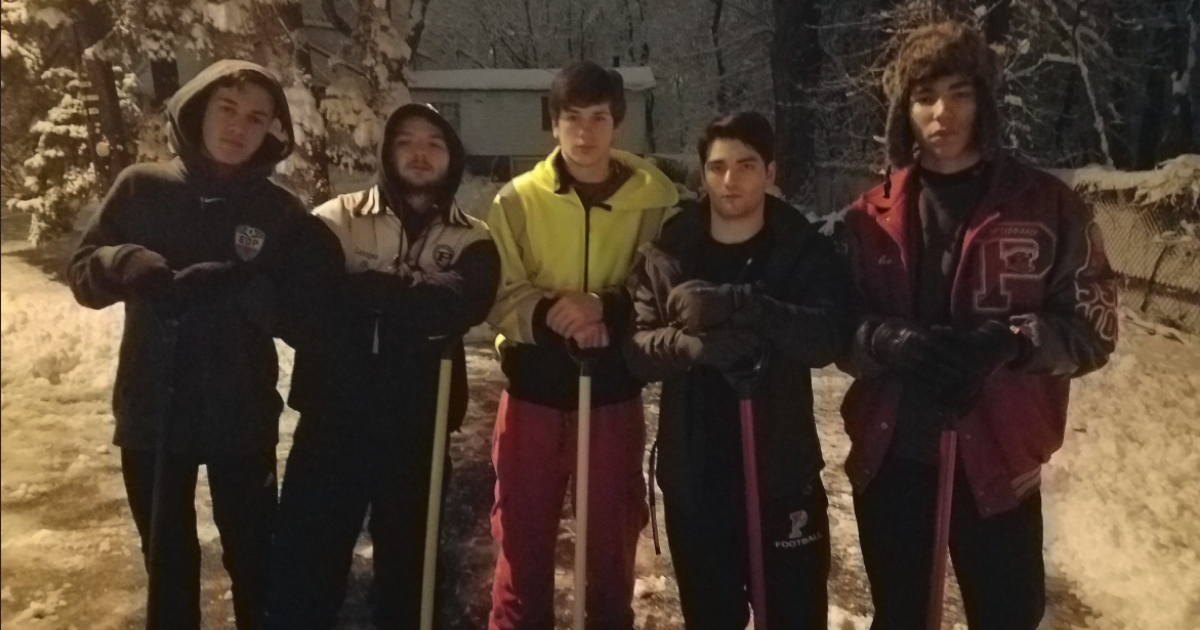 Group of high school boys with shovels.