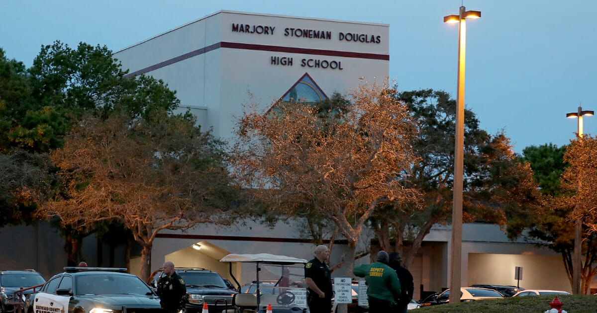 Law enforcement officers stand outside Marjory Stoneman Douglas High School on Feb. 14, the one-year anniversary of the mass shooting in Parkland, Florida.