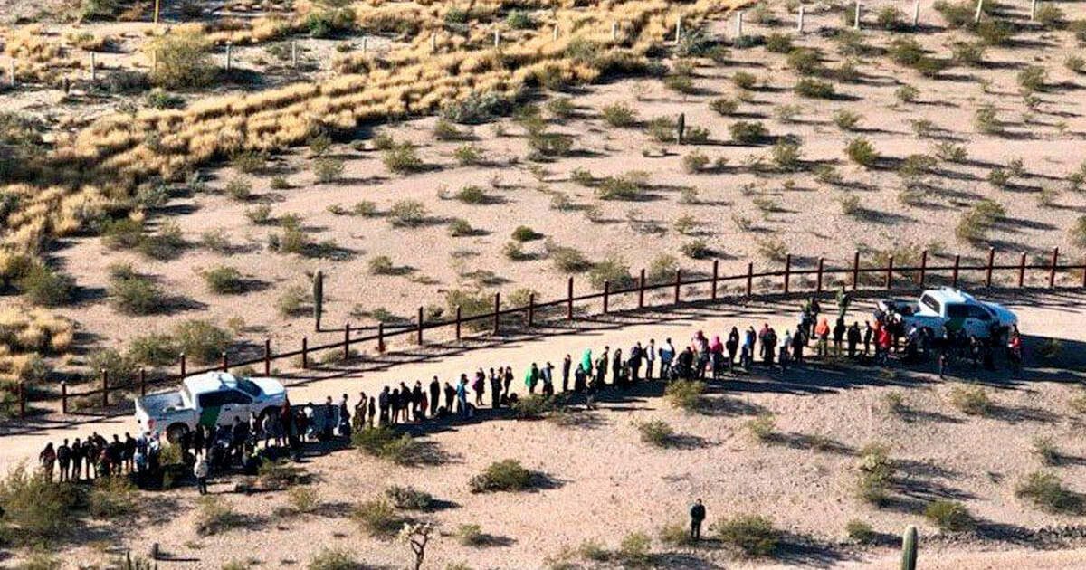 Illegal immigrants line up after they were apprehended along the U.S.-Mexico border near Lukeville, Arizona, Feb. 7, 2019.