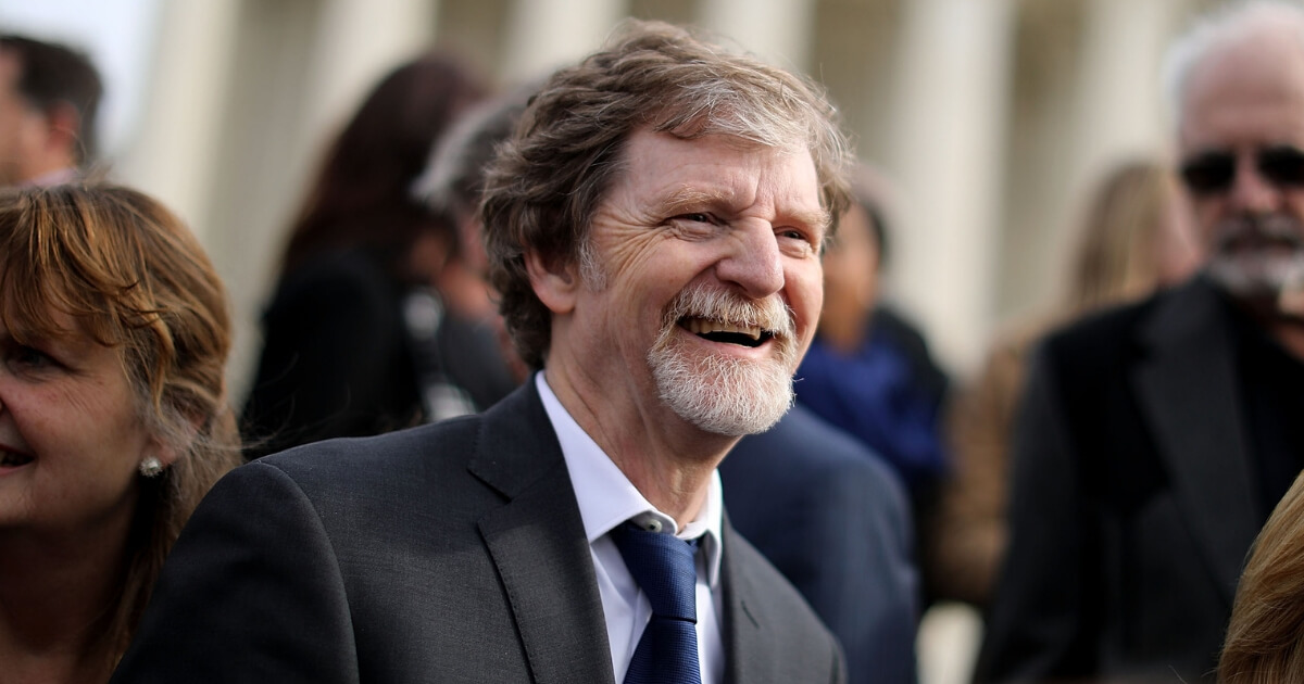 Conservative Christian baker Jack Phillips and members of his family and legal team pose for photographs in front of the Supreme Court after the court heard the case Masterpiece Cakeshop v. Colorado Civil Rights Commission Dec. 5, 2017, in Washington, D.C.