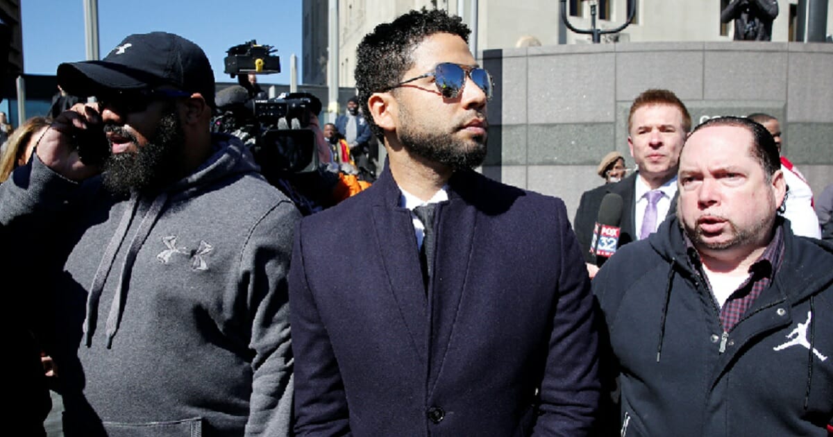 "Empire" actor Jussie Smollett leaves court in Chicago on Tuesday after charges were dropped against him in relation to an attack he allegedly staged in January.