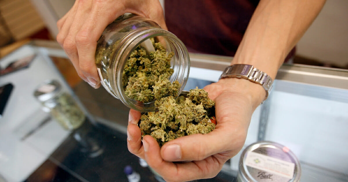 A budtender pours marijuana from a jar at Perennial Holistic Wellness Center medical marijuana dispensary, which opened in 2006, on July 25, 2012 in Los Angeles, California.