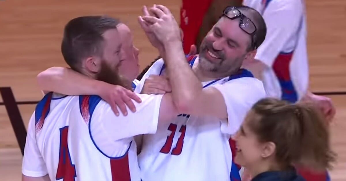 Team USA's Matt Millett, left, is hugged by teammates after his long-range shot at the buzzer against Team Canada.