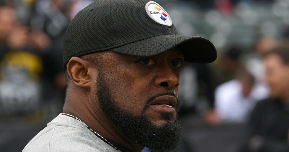 Head coach Mike Tomlin of the Pittsburgh Steelers looks on while his team warms up prior to the start of an NFL football game against the Oakland Raiders at Oakland-Alameda County Coliseum on Dec. 9, 2018 in Oakland, California.