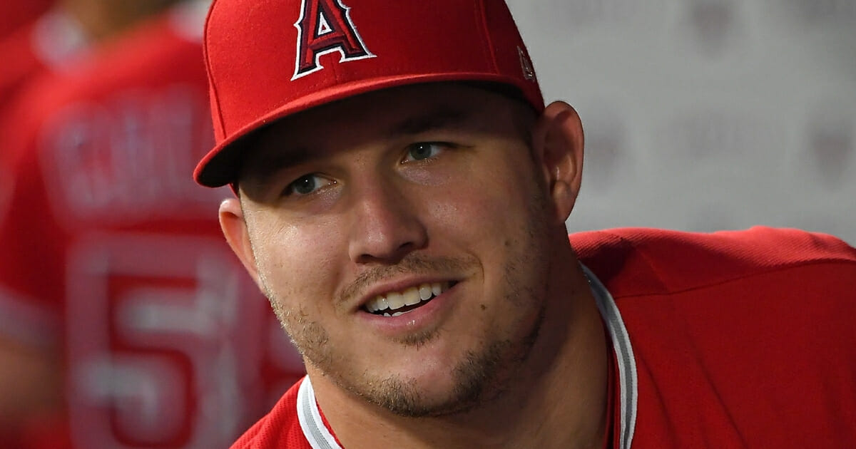Mike Trout of the Los Angeles Angels laughs in the dugout before a game against the Seattle Mariners on Sept. 13, 2018.