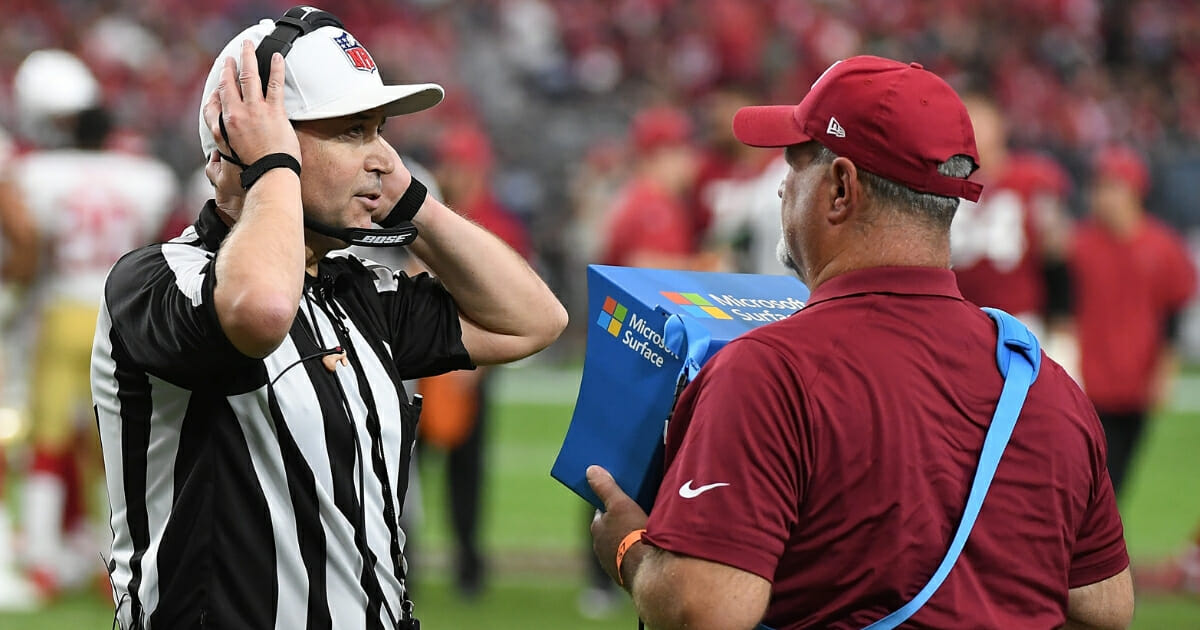 Referee Brad Allen studies the replay monitor while reviewing a play between the San Francisco 49ers and Arizona Cardinals on October 28, 2018, in Glendale, Arizona.