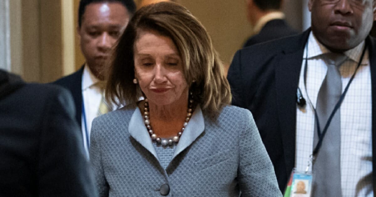 Nancy Pelosi frowning on Capitol Hill.