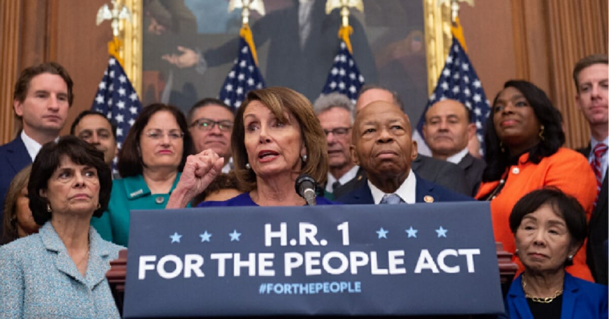 House Speaker Nancy Pelosi is surrounded by fellow Democrats at a news conference in January where she unvilved H.R. 1, the Democrats' "For the People Act."