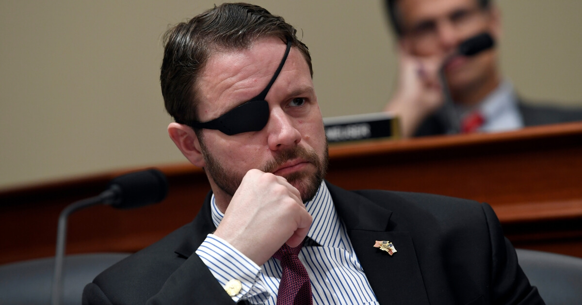 Rep. Dan Crenshaw, R-Texas, listens during a House Budget Committee hearing on Capitol Hill in Washington on March 12, 2019.