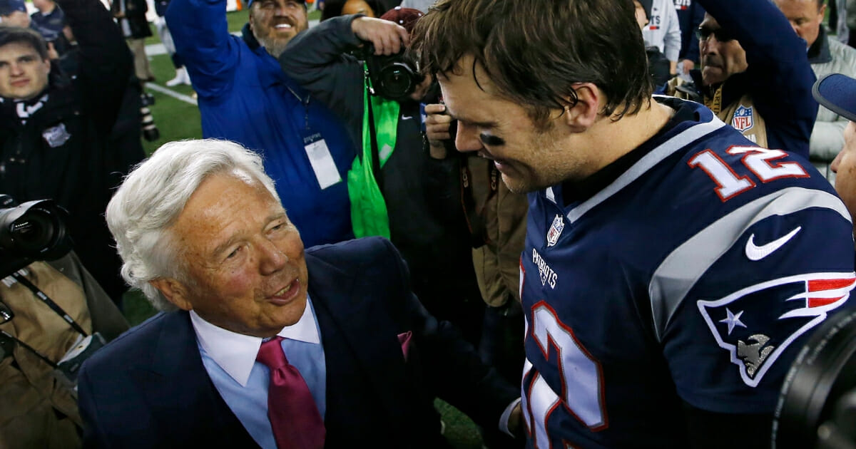 New England Patriots owner Robert Kraft talks with quarterback Tom Brady after the AFC championship game at Gillette Stadium in Foxborough, Massachusetts.