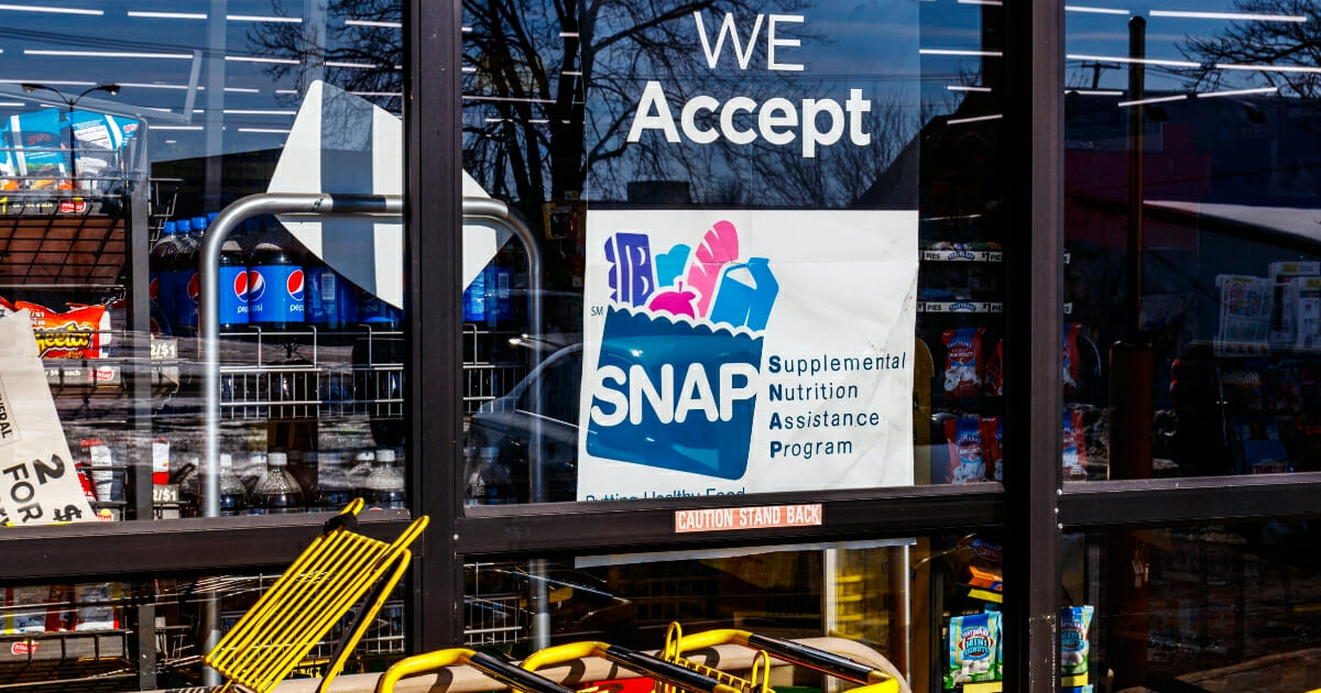 A SNAP sign on a grocery store window.
