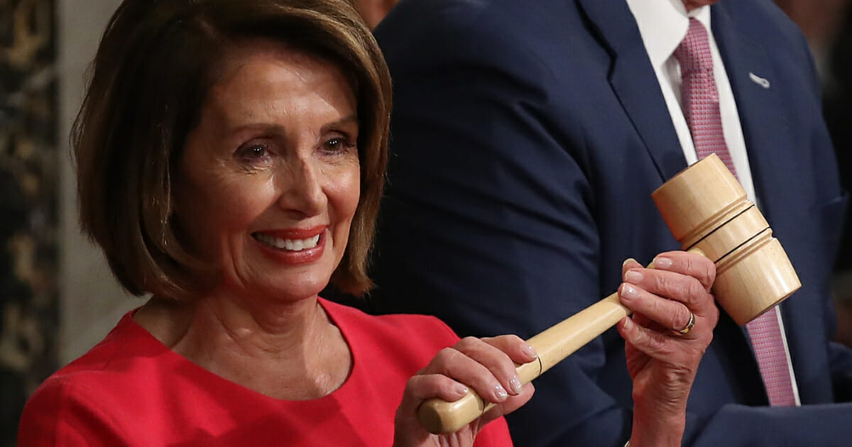House Speaker Nancy Pelosi, D-Calif., holds up the gavel following her election as speaker.
