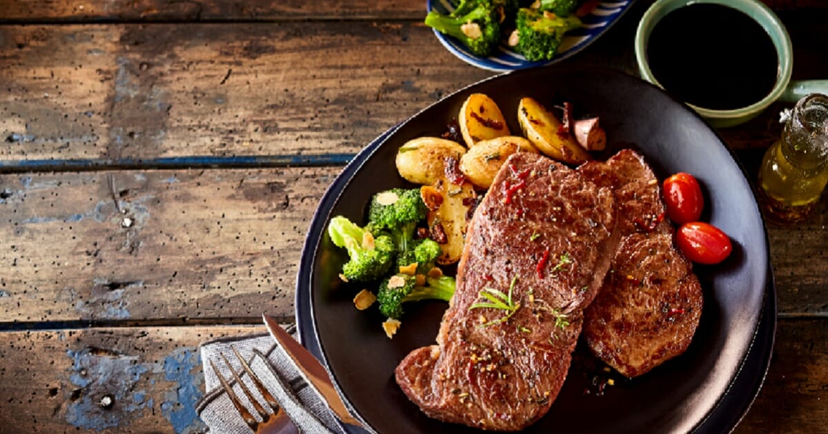 A plate of steak and potatoes.