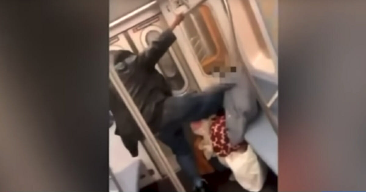 Image of a man kicking elderly woman on the New York City Subway.