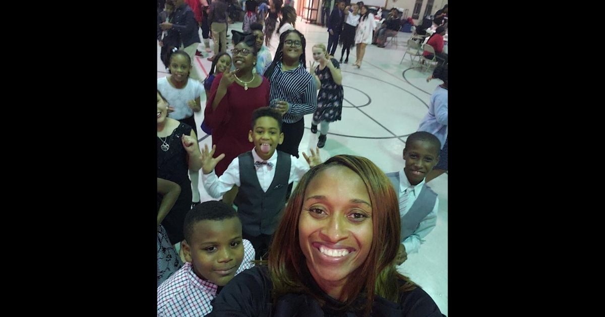Elementary school principal takes a selfie with her students