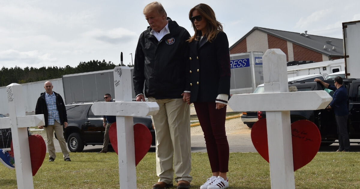 President Donald Trump and First Lady Melania Trump pay their respects Friday, March 8, 2019, honoring 23 people who died due to a storm in Alabama.