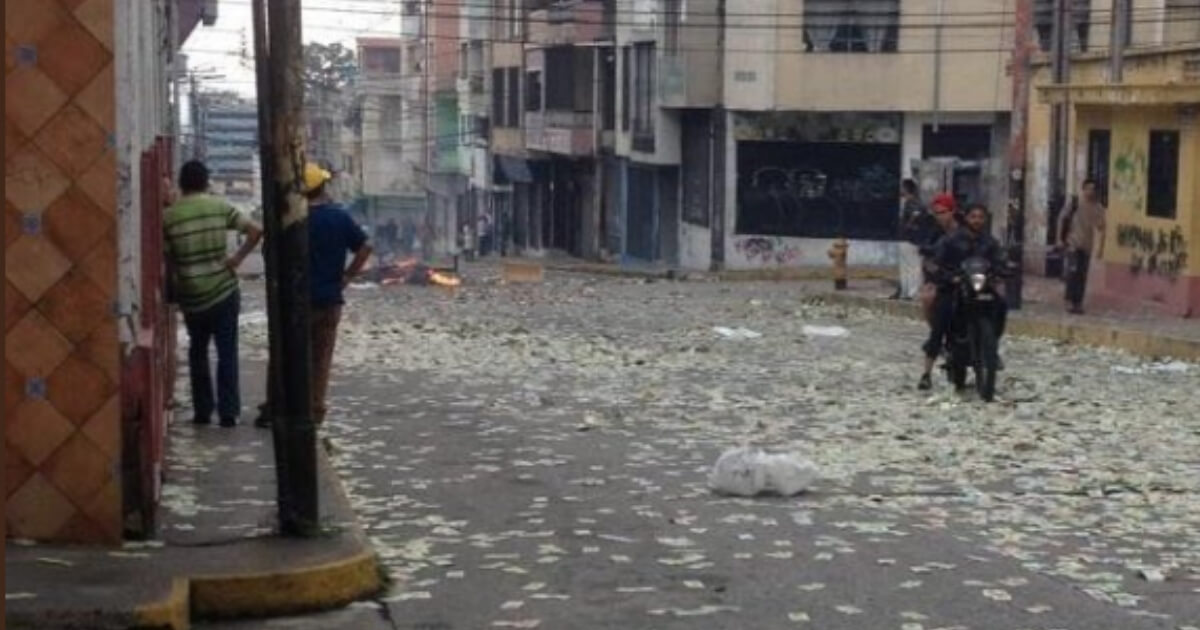 Useless bolivars litter a Venezuela street.