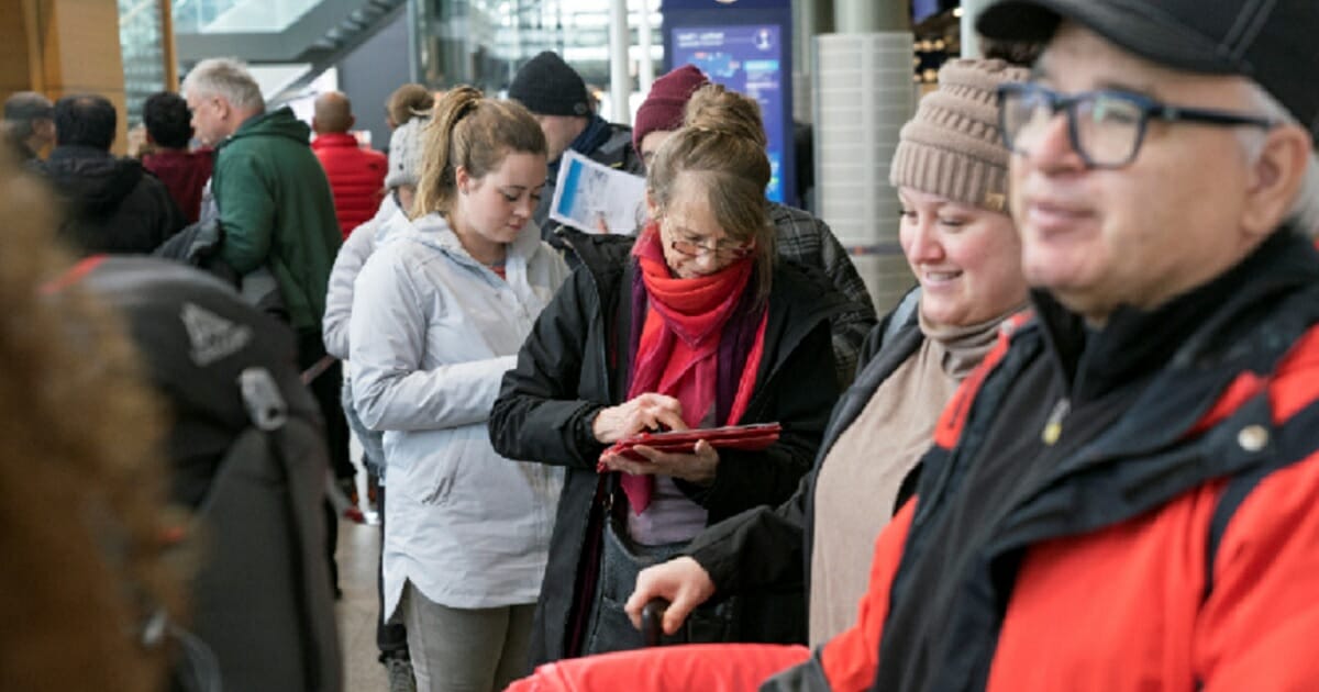 Stranded passengers who planned to travel on the Icelandic airline Wow wait in line at Iceland's international airport in Kflavik on Thursday.