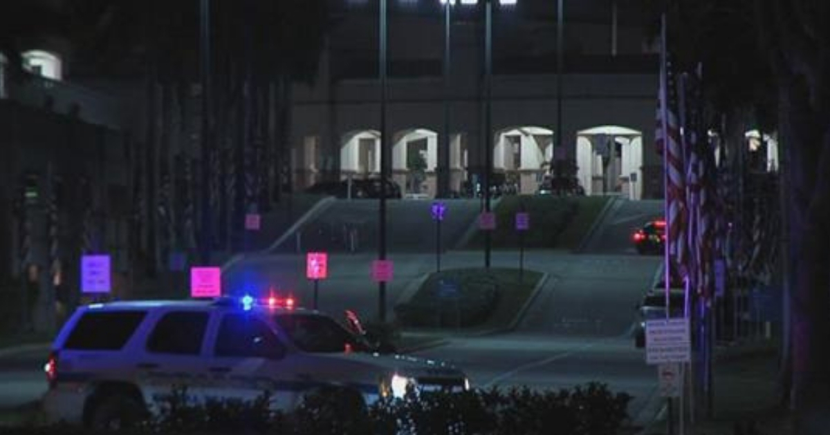 Florida Veteran Affairs hospital at night with a police SUV parked outside.