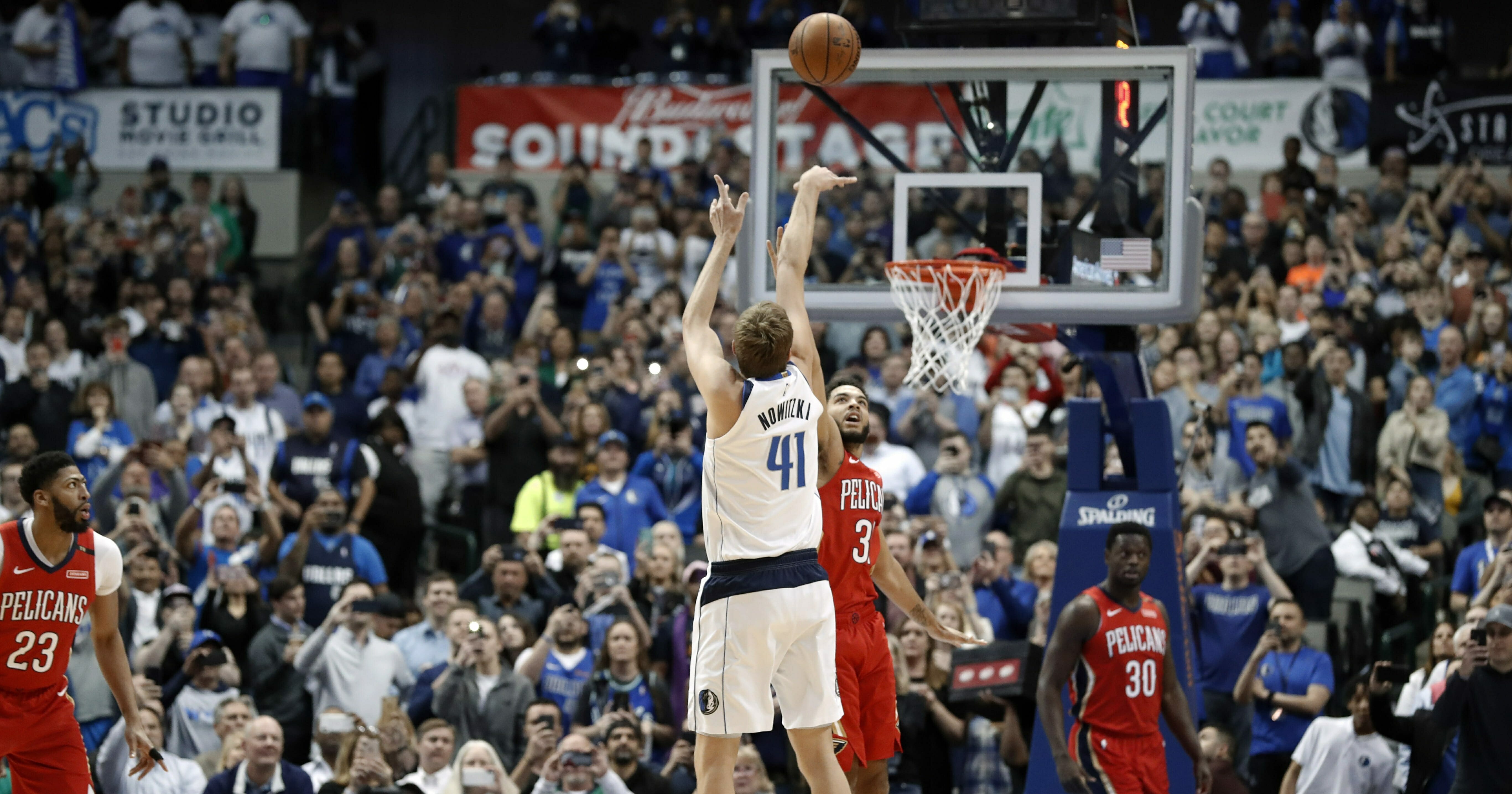 Dallas Mavericks forward Dirk Nowitzki shoots as New Orleans Pelicans’ Kenrich Williams defends in the first half of an NBA basketball game in Dallas, Monday, March 18, 2019.