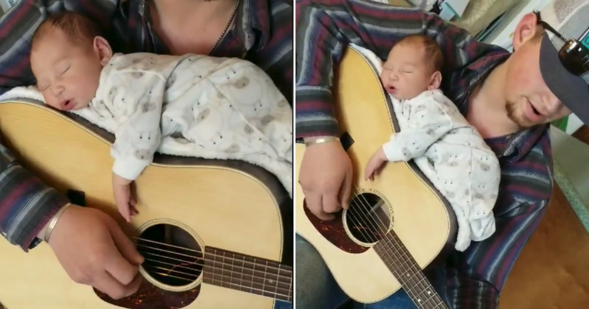 A tiny baby asleep on a guitar that her dad is playing.
