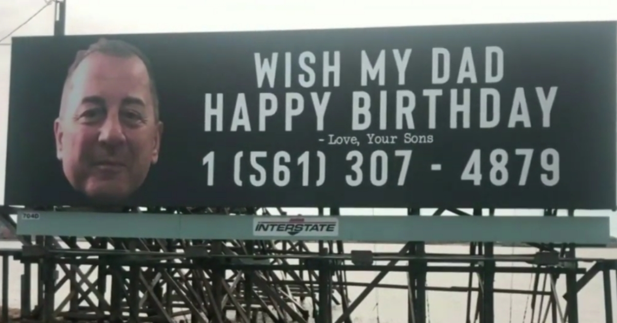 Billboard with a man's face and phone number on it.