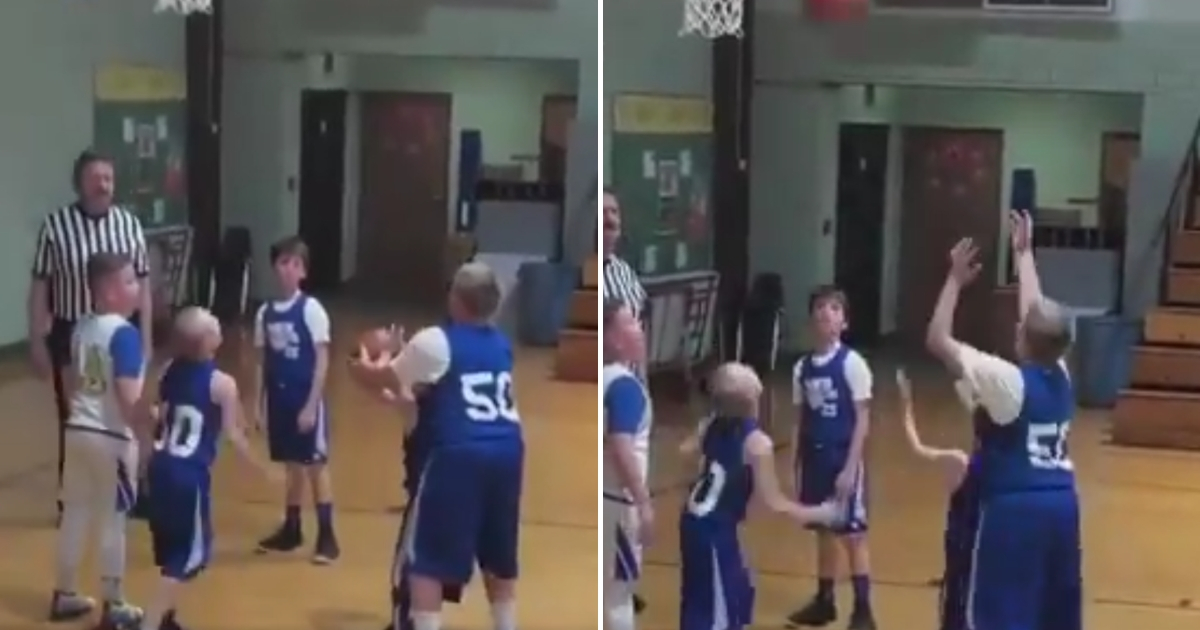 Teammate helps boy with cerebral palsy shoot a basket.