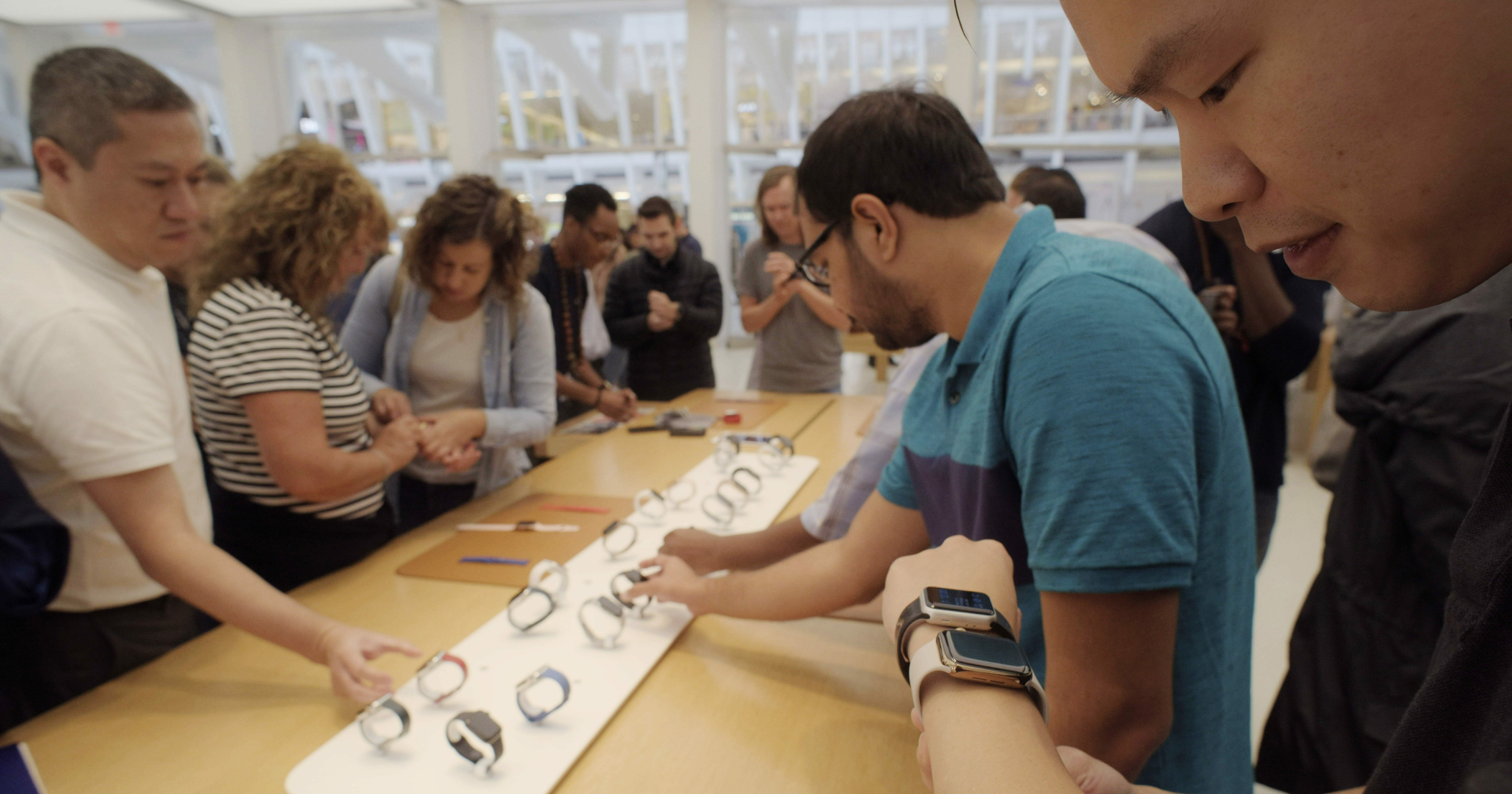 Customers look at Apple Watches at an Apple store in New York on Sept. 21, 2018.