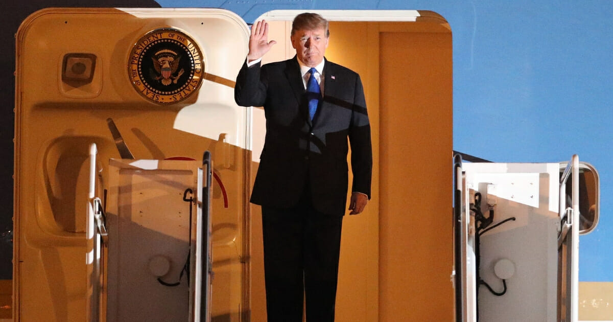 President Donald Trump waves after arriving at Noi Bai airport in Hanoi on Feb. 26, 2019.