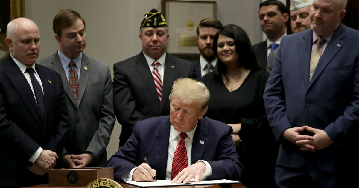 President Donald Trump signs an executive order at the White House on the “National Roadmap to Empower Veterans and End Veteran Suicide” March 5, 2019 in Washington, D.C.