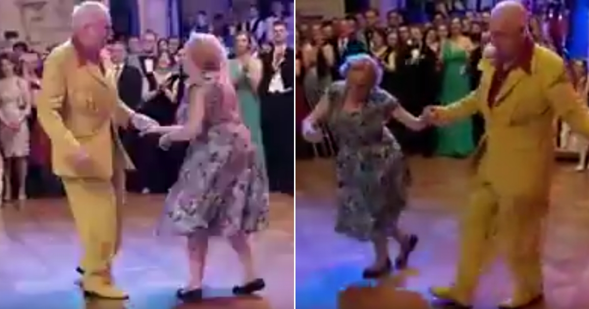 An elderly couple dancing.