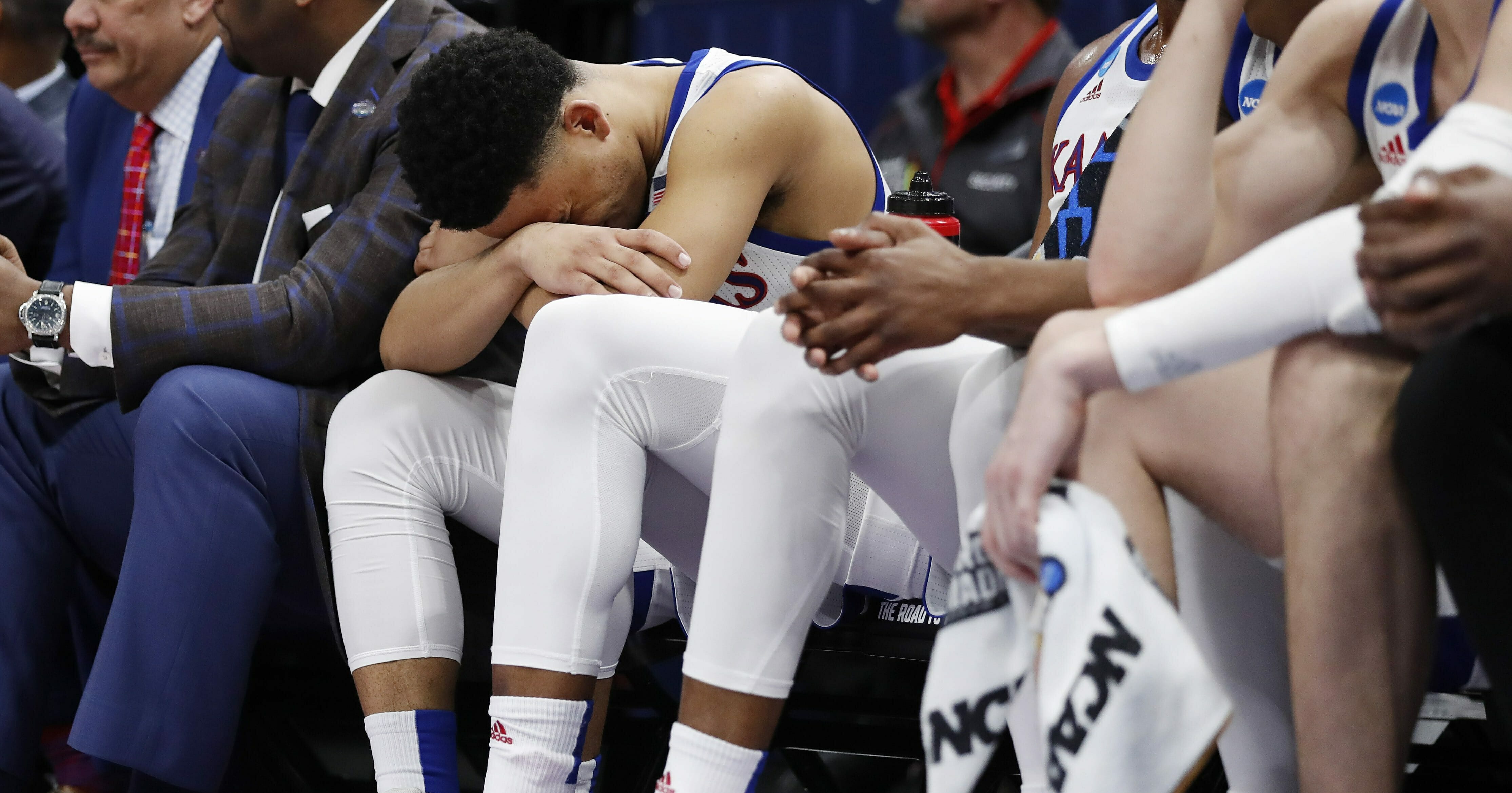 Kansas guard Devon Dotson sits on the bench in the closing minutes of the team's loss to Auburn in a second-round game in the NCAA men's college basketball tournament Saturday, Mar. 23, 2019, in Salt Lake City.