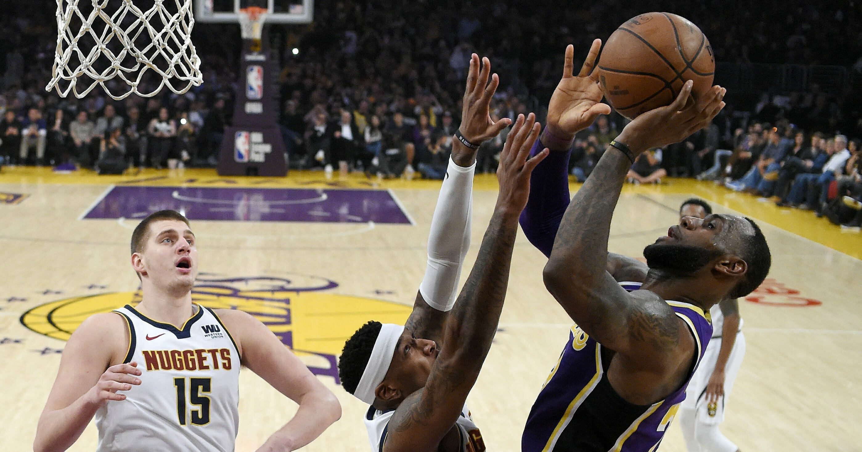 Los Angeles Lakers forward LeBron James shoots and scores against the Denver Nuggets on March 6, 2019 in Los Angeles