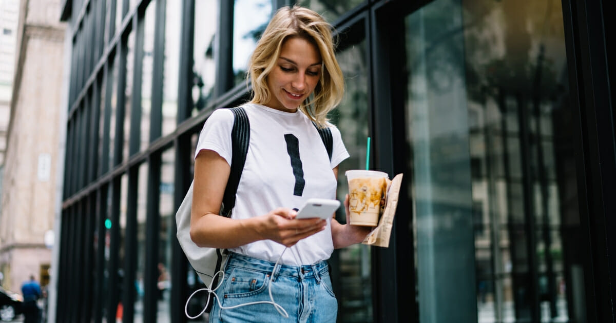Girl with cellphone and coffee
