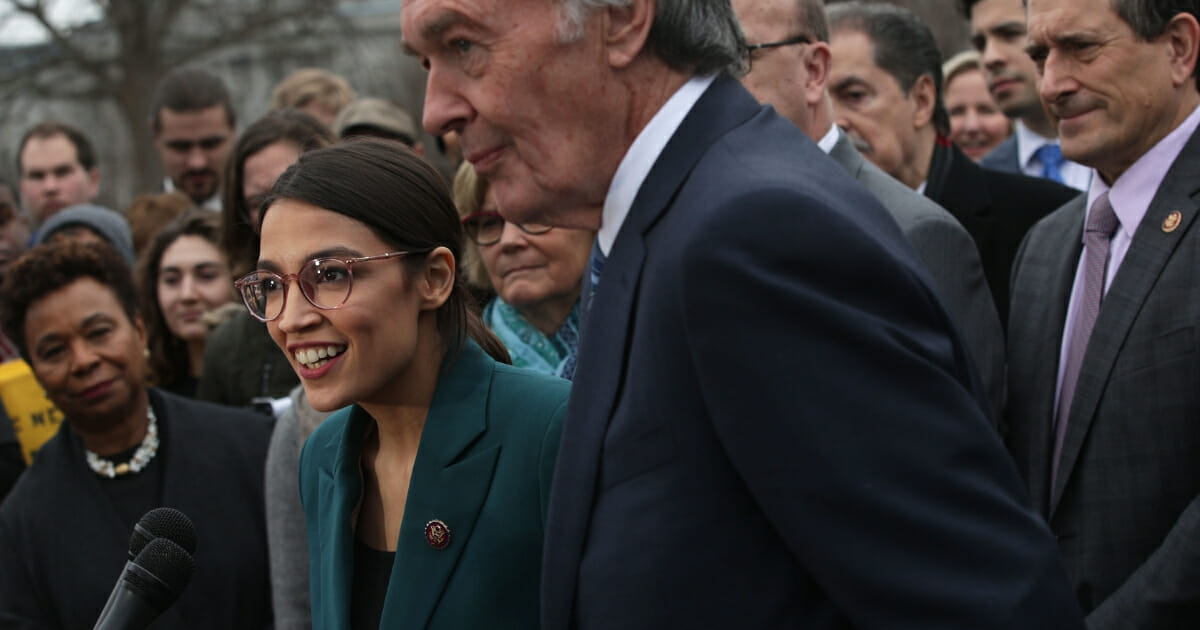 Rep. Alexandria Ocasio-Cortez speaks as Sen. Ed Markey and other congressional Democrats listen during a news conference in front of the U.S. Capitol Feb. 7, 2019.