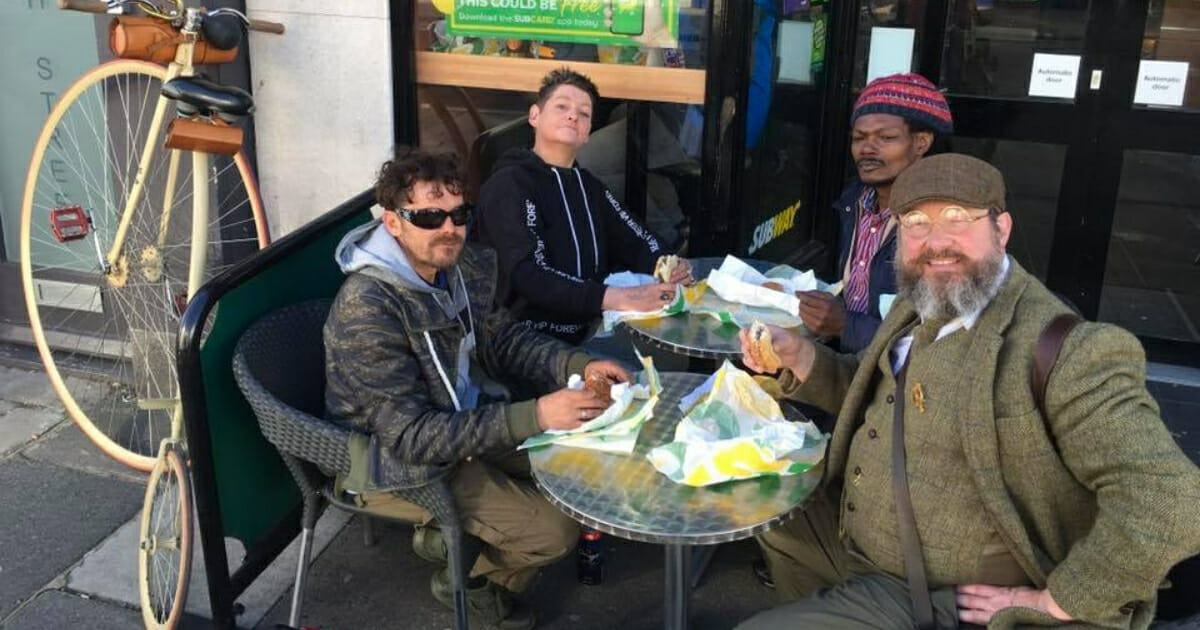 A group of men eating at Subway.