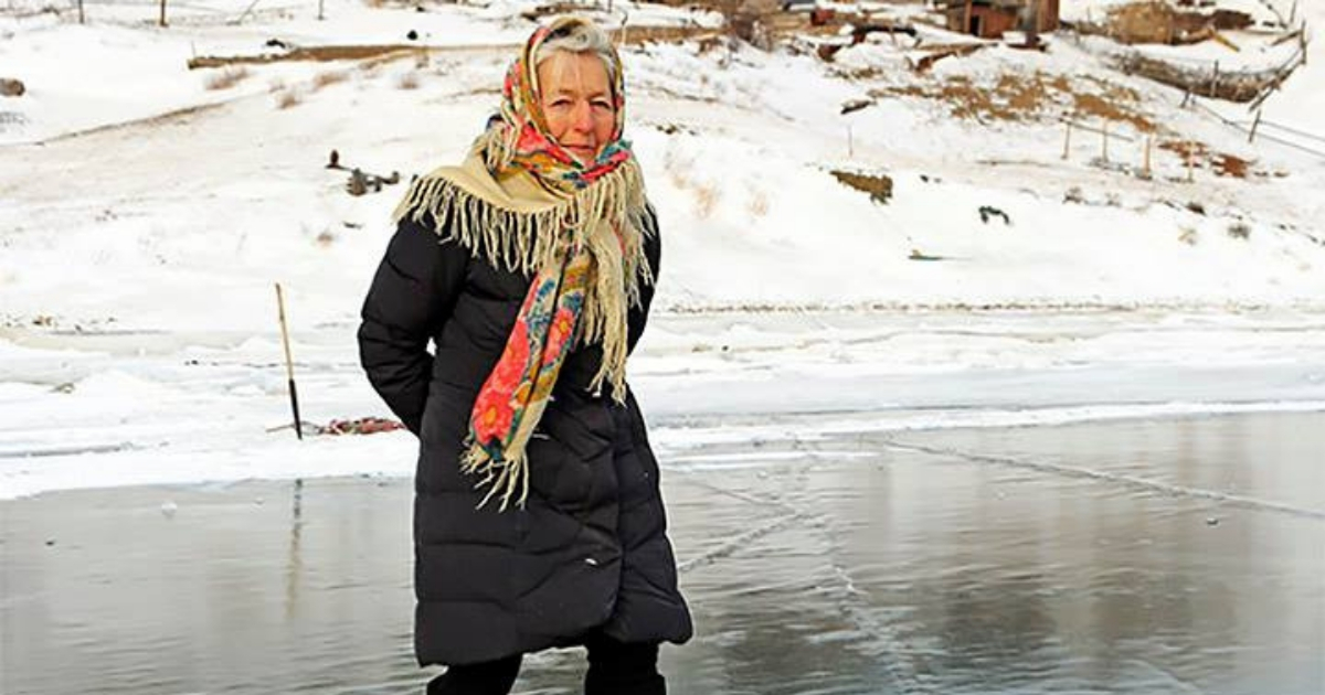 Elderly woman on a lake