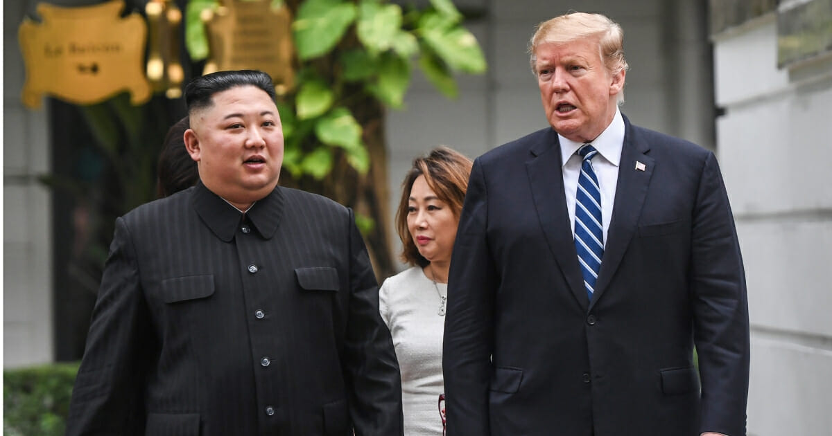 President Donald Trump walks with North Korea's leader Kim Jong Un during a break in talks at the second US-North Korea summit.